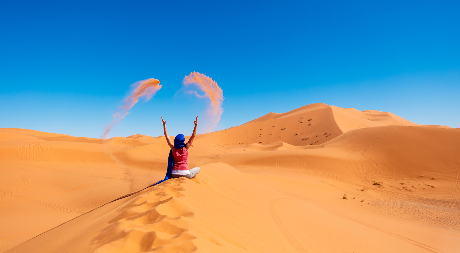 Woman in the desert threw sand- Morocco