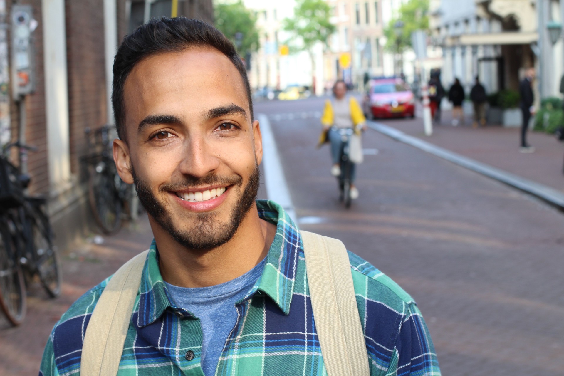 Handsome ethnic young male smiling outdoors