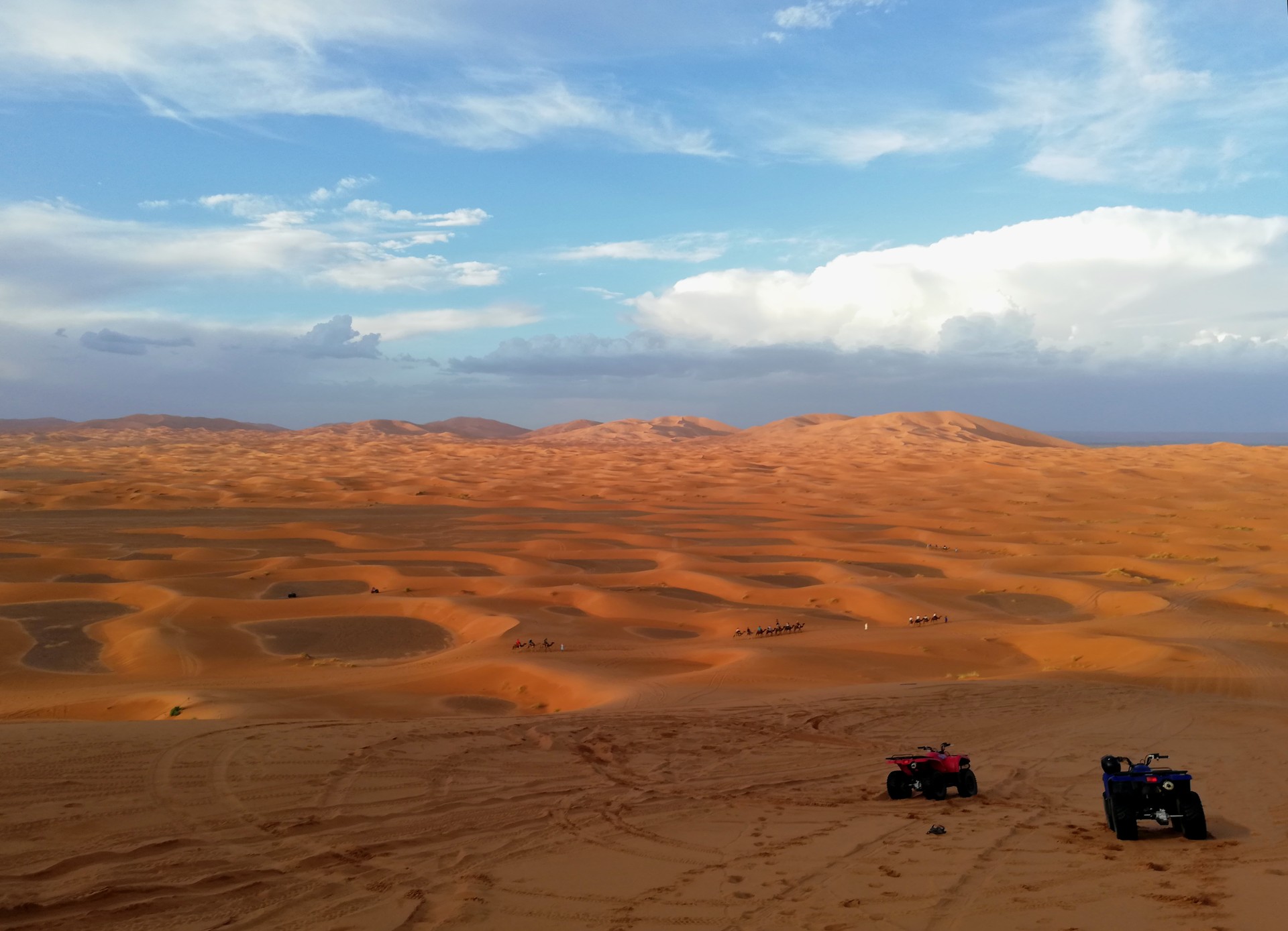 View of the Sahara desert with quads and camels