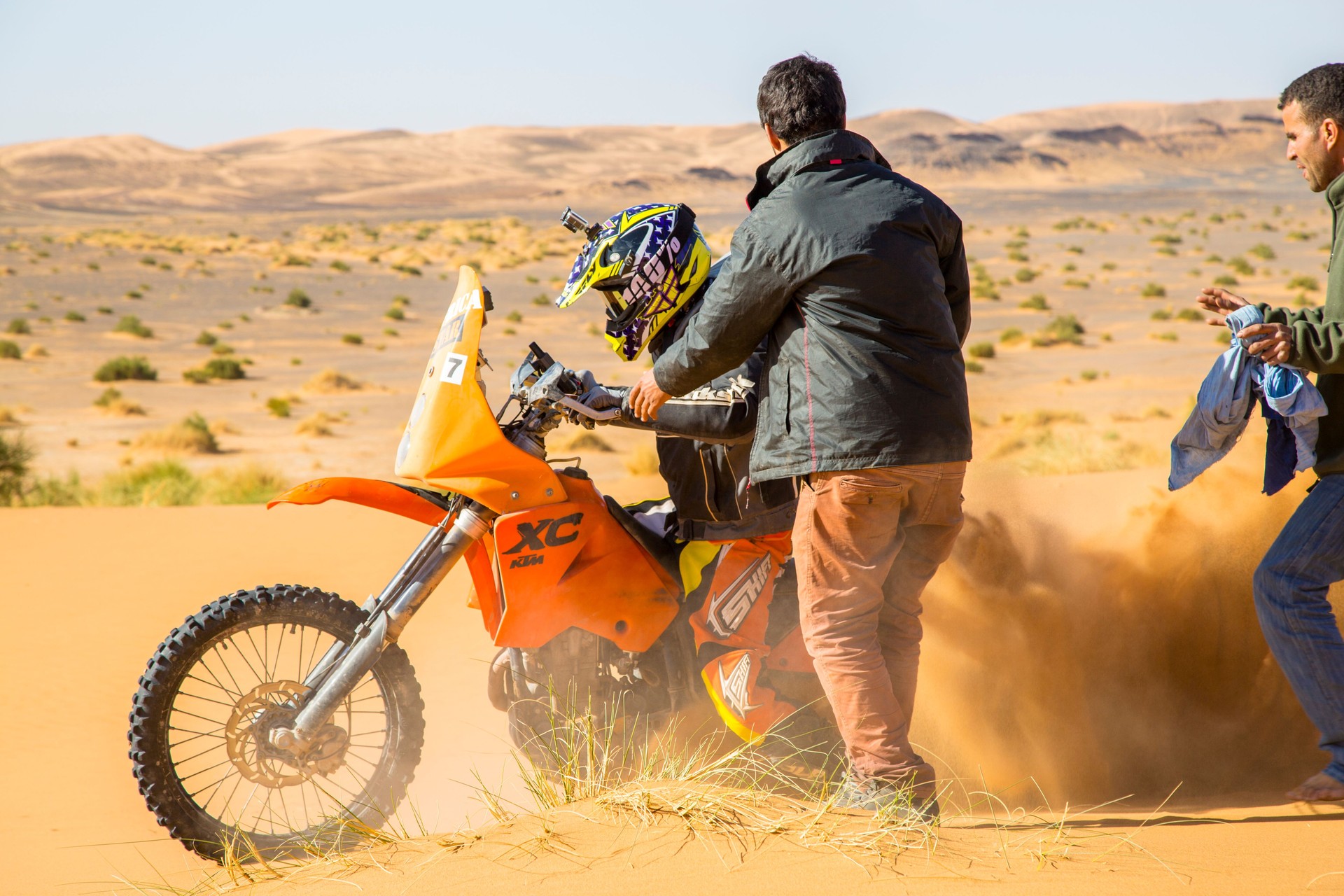 A motorbike rider churns up sand in the Sahara Desert