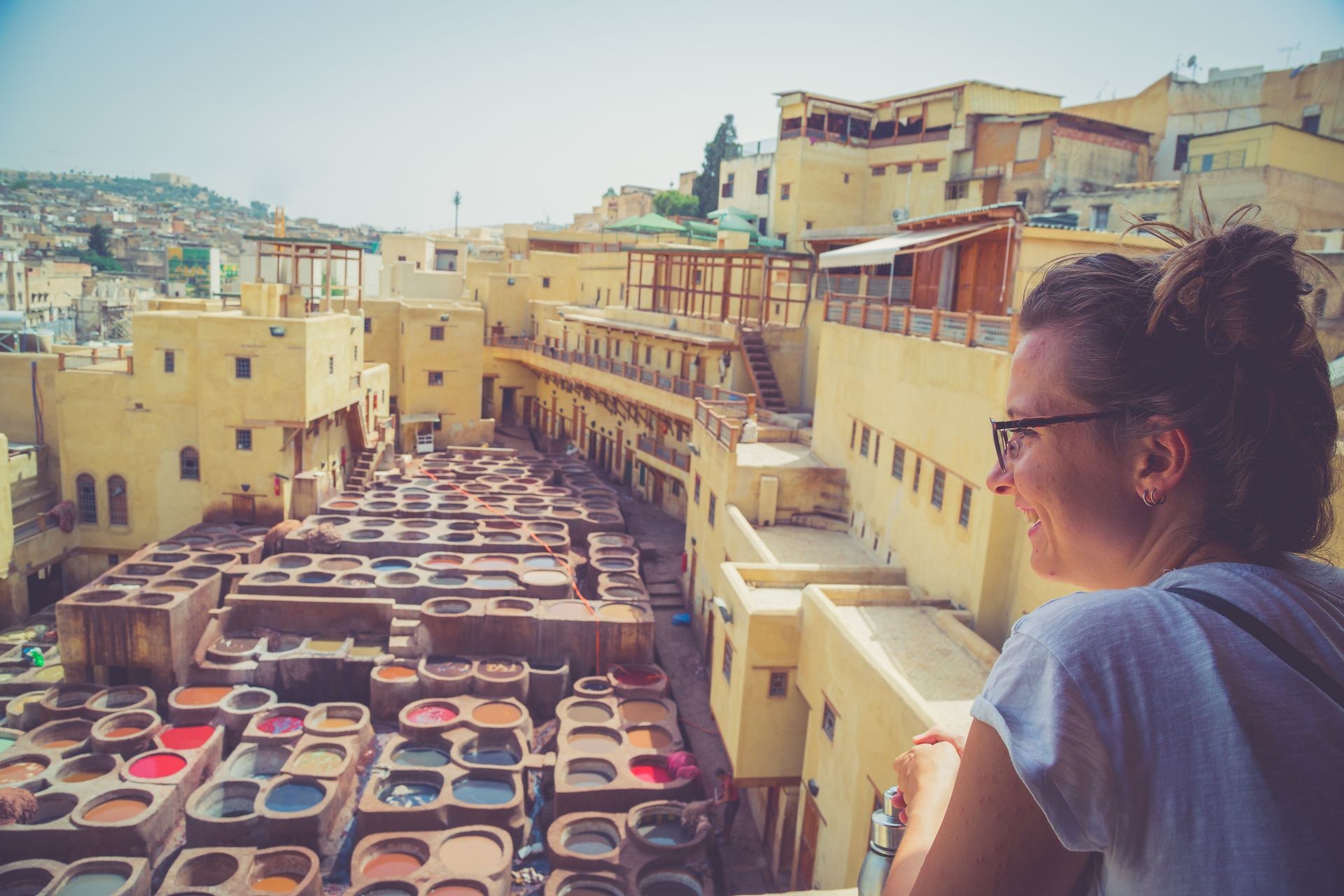 Tourist girl is watching the Tannery in the middle of souk of Fez, traditional leather tannery from the 11th century is now biggest tourist attraction in Fes.